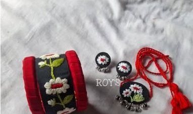Black cuff with white daisies and red edges